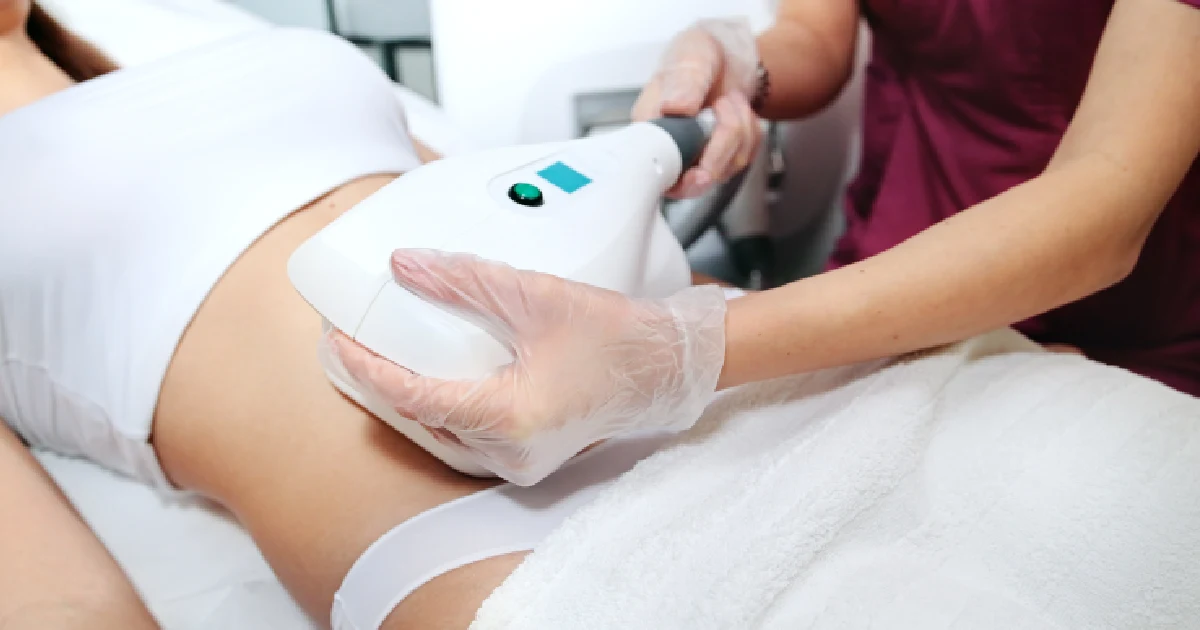 A woman lying comfortably on a treatment table at Liv Aesthetics Medical Spa in Thornwood, NY, as a specialist applies a CoolSculpting applicator to her midsection, illustrating non‑invasive fat‑freezing body contouring.