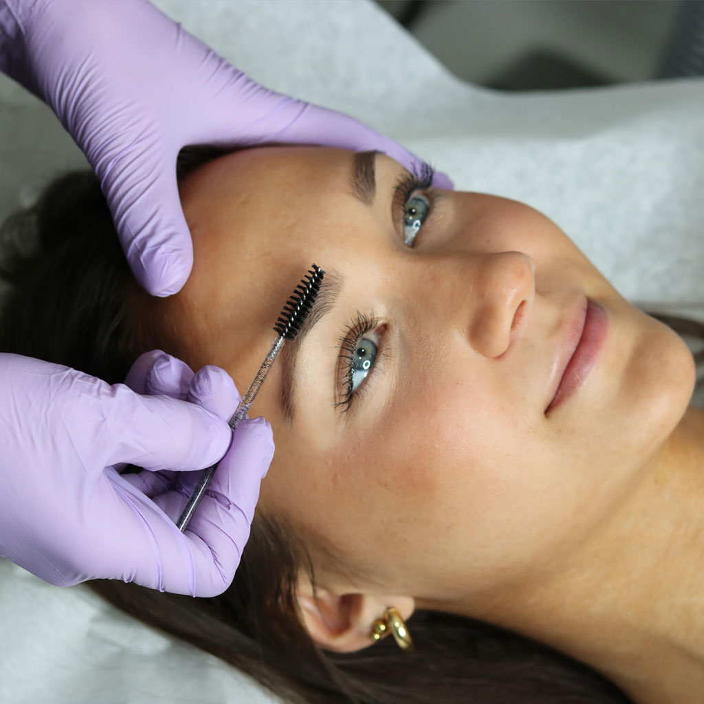 caucasian woman getting eye brow treatment